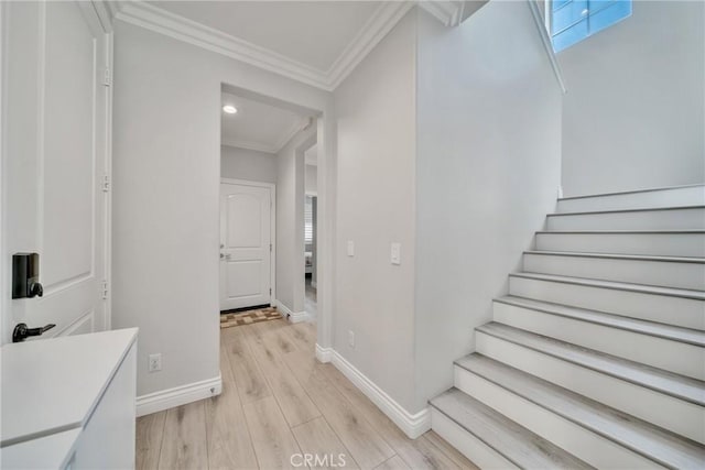 staircase with hardwood / wood-style flooring and crown molding