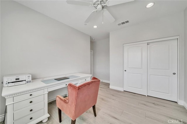 home office featuring ceiling fan and light hardwood / wood-style flooring