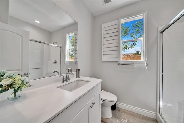 bathroom featuring an enclosed shower, toilet, and wood-type flooring