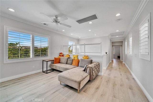 living room with crown molding, light hardwood / wood-style flooring, and ceiling fan