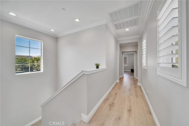 hall featuring light wood-type flooring and ornamental molding