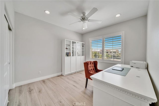 office area with ceiling fan and light hardwood / wood-style flooring