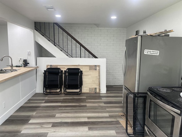 kitchen with sink, dark hardwood / wood-style flooring, and appliances with stainless steel finishes