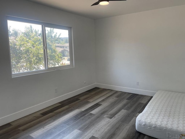 unfurnished bedroom with dark hardwood / wood-style flooring and ceiling fan