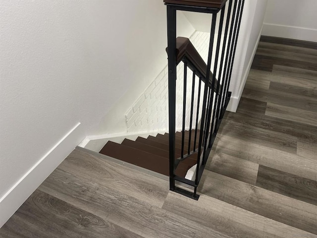 staircase with hardwood / wood-style floors