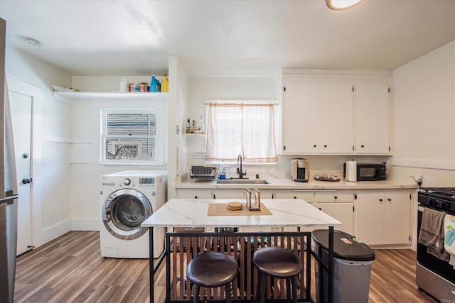 interior space featuring sink, dark wood-type flooring, and washer / clothes dryer