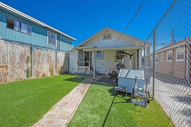 rear view of house with a lawn