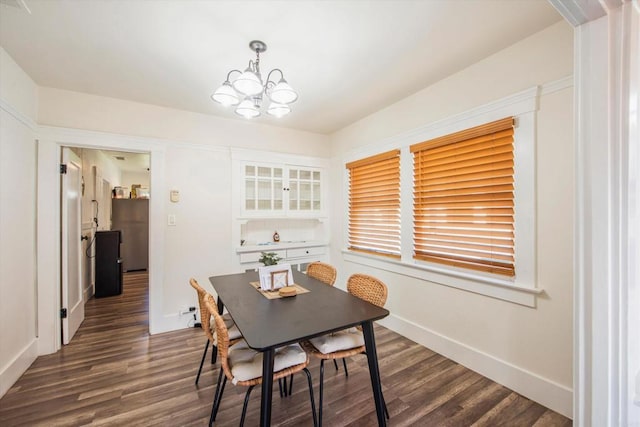 dining room featuring an inviting chandelier and dark hardwood / wood-style flooring