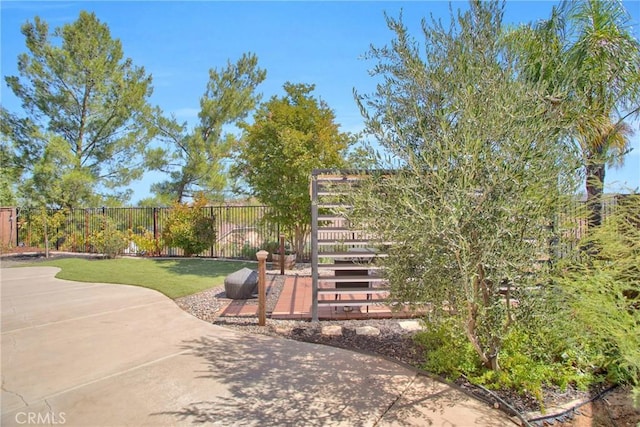 surrounding community with fence and a patio area