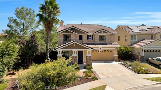 craftsman-style home with driveway, stone siding, an attached garage, stucco siding, and a chimney