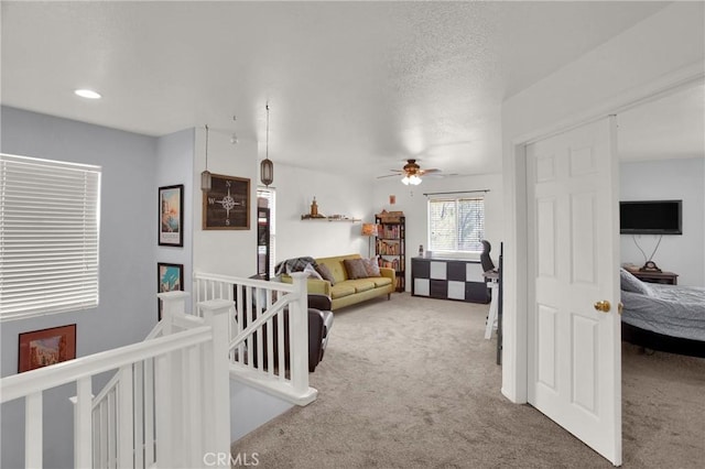 living area with carpet flooring, ceiling fan, and recessed lighting