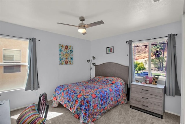 bedroom with carpet floors, ceiling fan, and baseboards