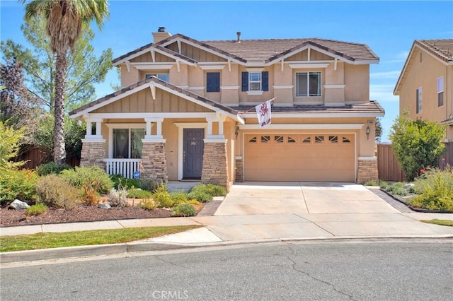 craftsman-style home with stone siding, covered porch, an attached garage, concrete driveway, and stucco siding