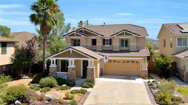 craftsman-style home featuring a mountain view and a garage