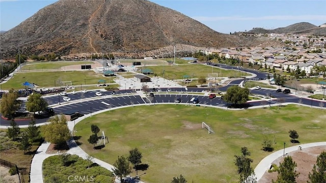 view of property location featuring mountains and nearby suburban area
