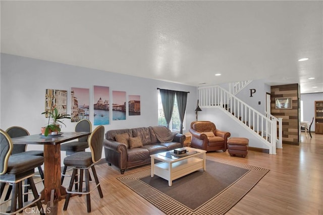living area featuring stairs, wood finished floors, and recessed lighting