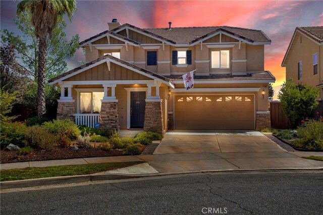 craftsman-style house featuring a porch and a garage