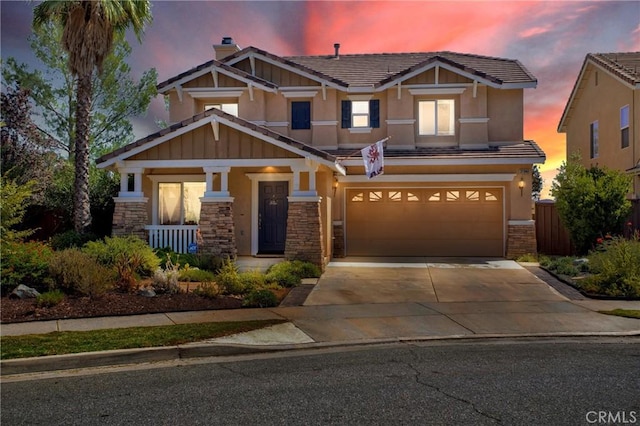 craftsman house with stone siding, an attached garage, concrete driveway, a porch, and stucco siding