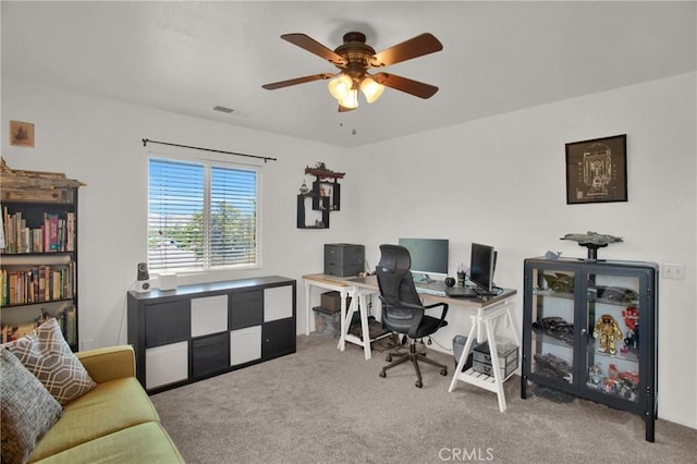 carpeted office with ceiling fan