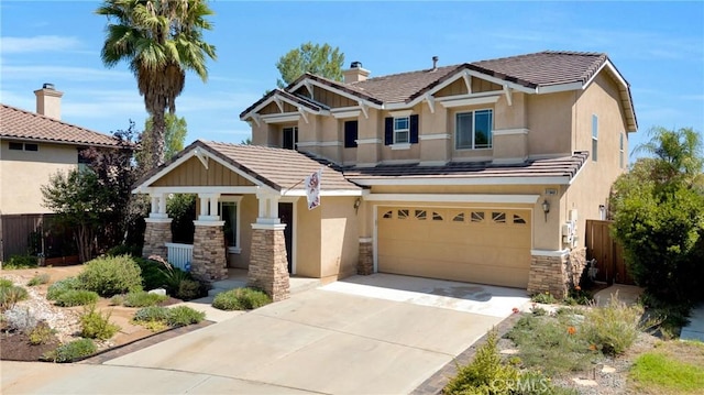 craftsman-style house featuring fence, stucco siding, and a garage