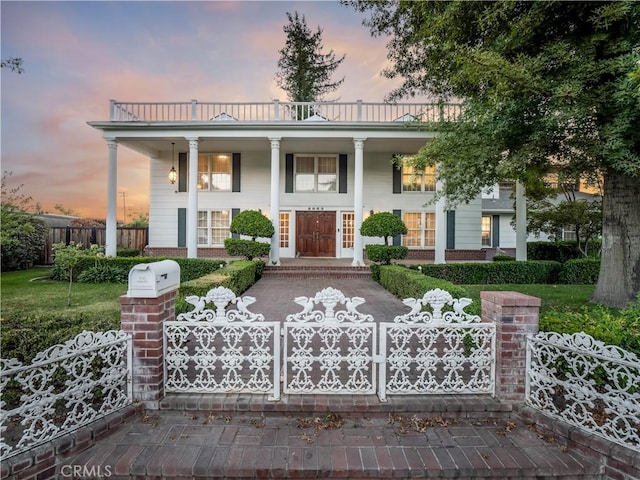 neoclassical / greek revival house featuring a balcony and a porch