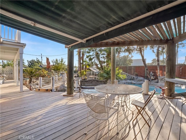 deck with a pergola and a fenced in pool