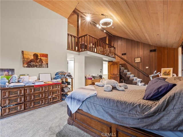 carpeted bedroom with lofted ceiling, wood walls, and wooden ceiling