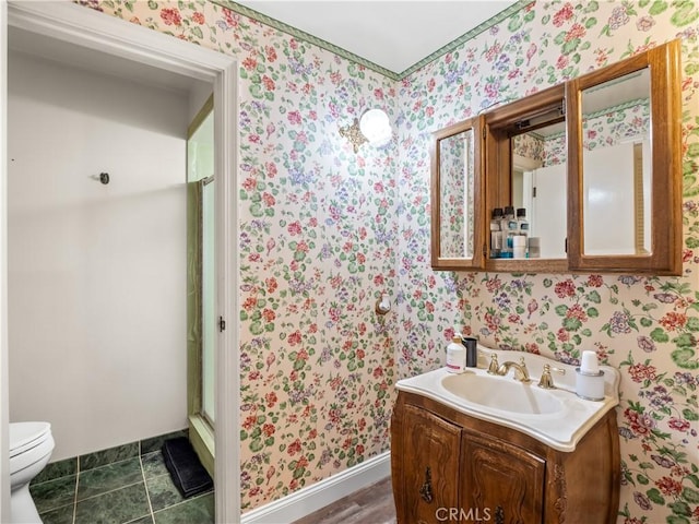 bathroom featuring tile patterned floors, vanity, toilet, and walk in shower