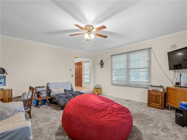 carpeted living room with ceiling fan and crown molding