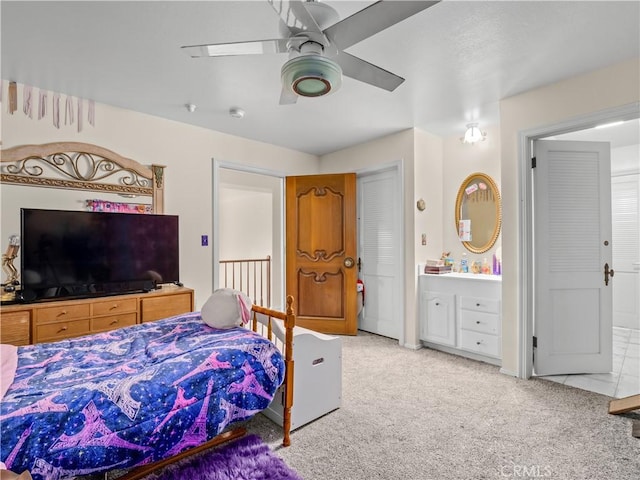 bedroom featuring carpet flooring, connected bathroom, and ceiling fan