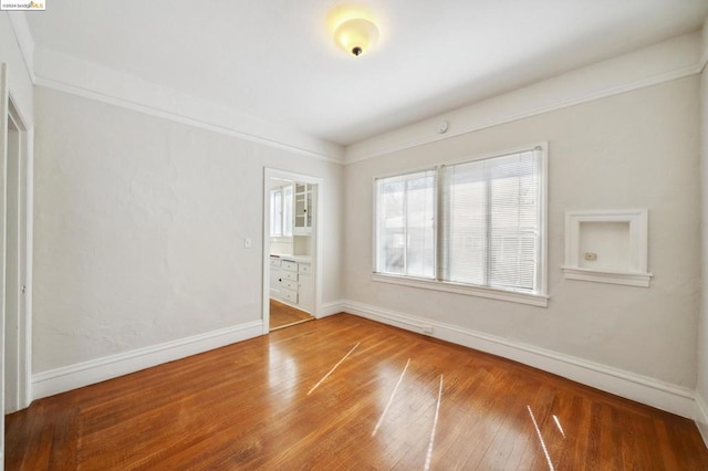 unfurnished bedroom with hardwood / wood-style floors