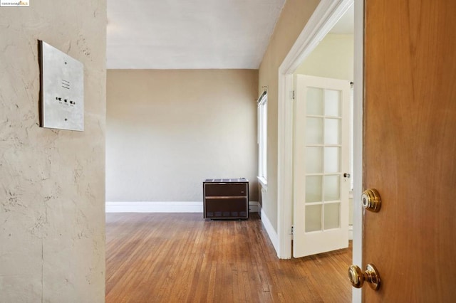 hallway with wood-type flooring