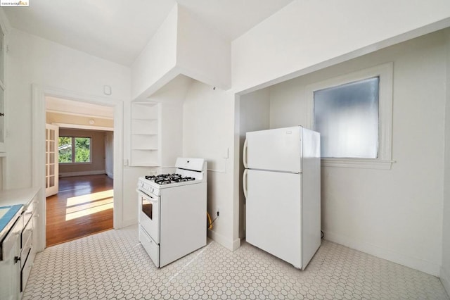 kitchen with light wood-type flooring and white appliances