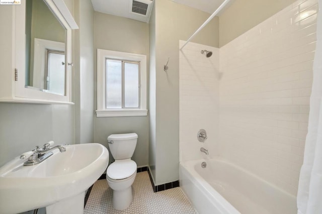 full bathroom featuring shower / bath combo, tile patterned flooring, toilet, and sink