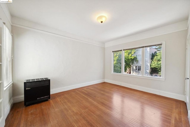 spare room featuring hardwood / wood-style flooring and heating unit