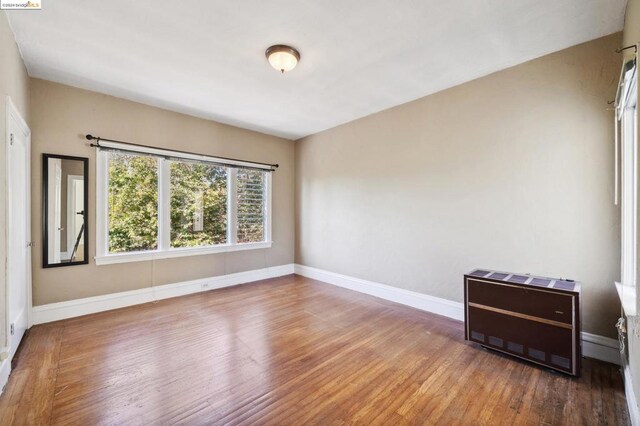 unfurnished room featuring wood-type flooring