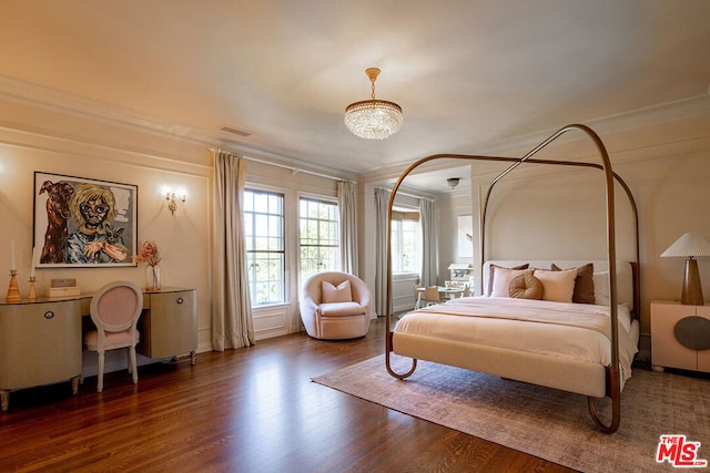 bedroom featuring a notable chandelier, crown molding, and dark hardwood / wood-style flooring