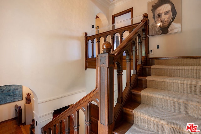 staircase featuring ornamental molding