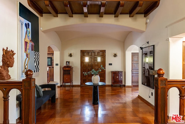 foyer featuring wood ceiling, lofted ceiling with beams, and dark wood-type flooring