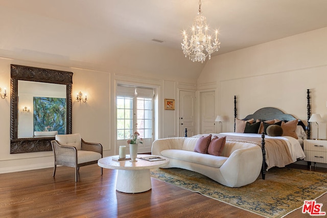 bedroom with lofted ceiling, a chandelier, and hardwood / wood-style flooring