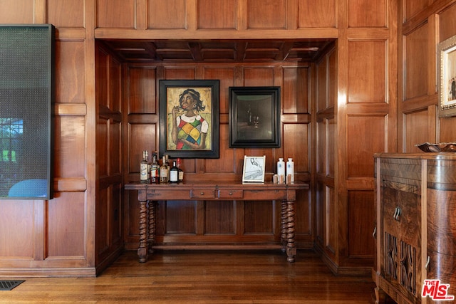 bar featuring wood walls and dark hardwood / wood-style floors