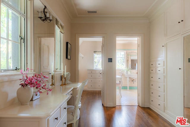 interior space with ornamental molding and hardwood / wood-style floors