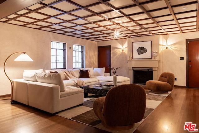 living room featuring coffered ceiling and light hardwood / wood-style flooring