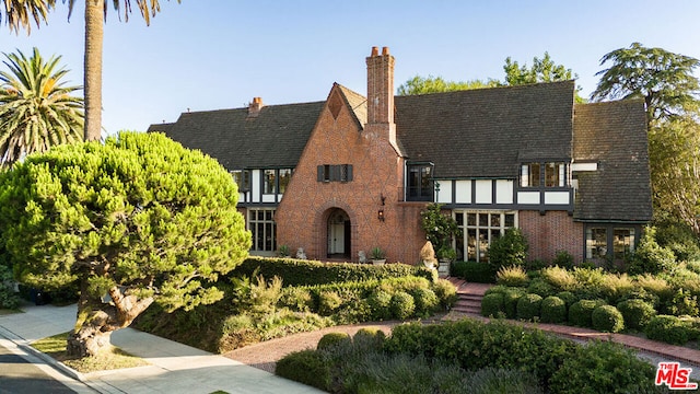 tudor-style house featuring a balcony