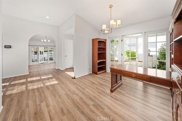 unfurnished office with a chandelier and light hardwood / wood-style flooring