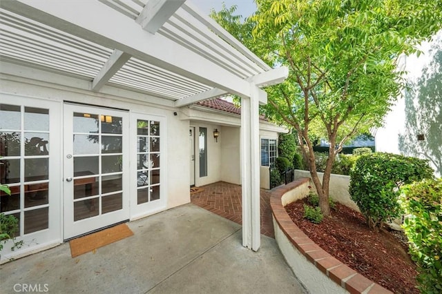 view of patio / terrace featuring french doors and a pergola