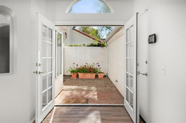 doorway with hardwood / wood-style flooring and french doors