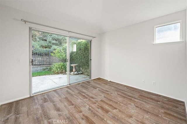 empty room with wood finished floors and baseboards