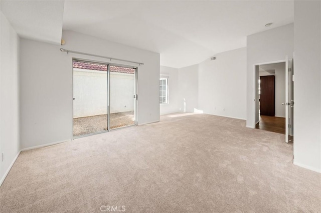 unfurnished bedroom featuring lofted ceiling and carpet floors