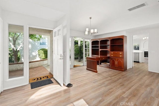 unfurnished office with light wood-type flooring and a notable chandelier